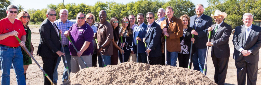 Group of Texas HFA staff at a groundbreaking, holding shovels