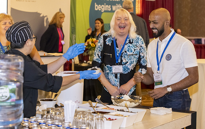 Two people laughing as ice cream is served