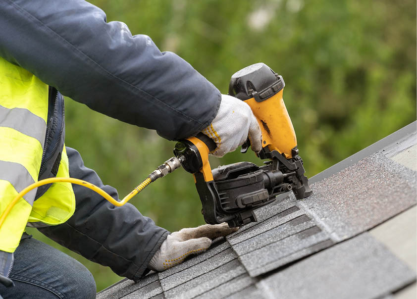 Work Person fixing roof with power tool